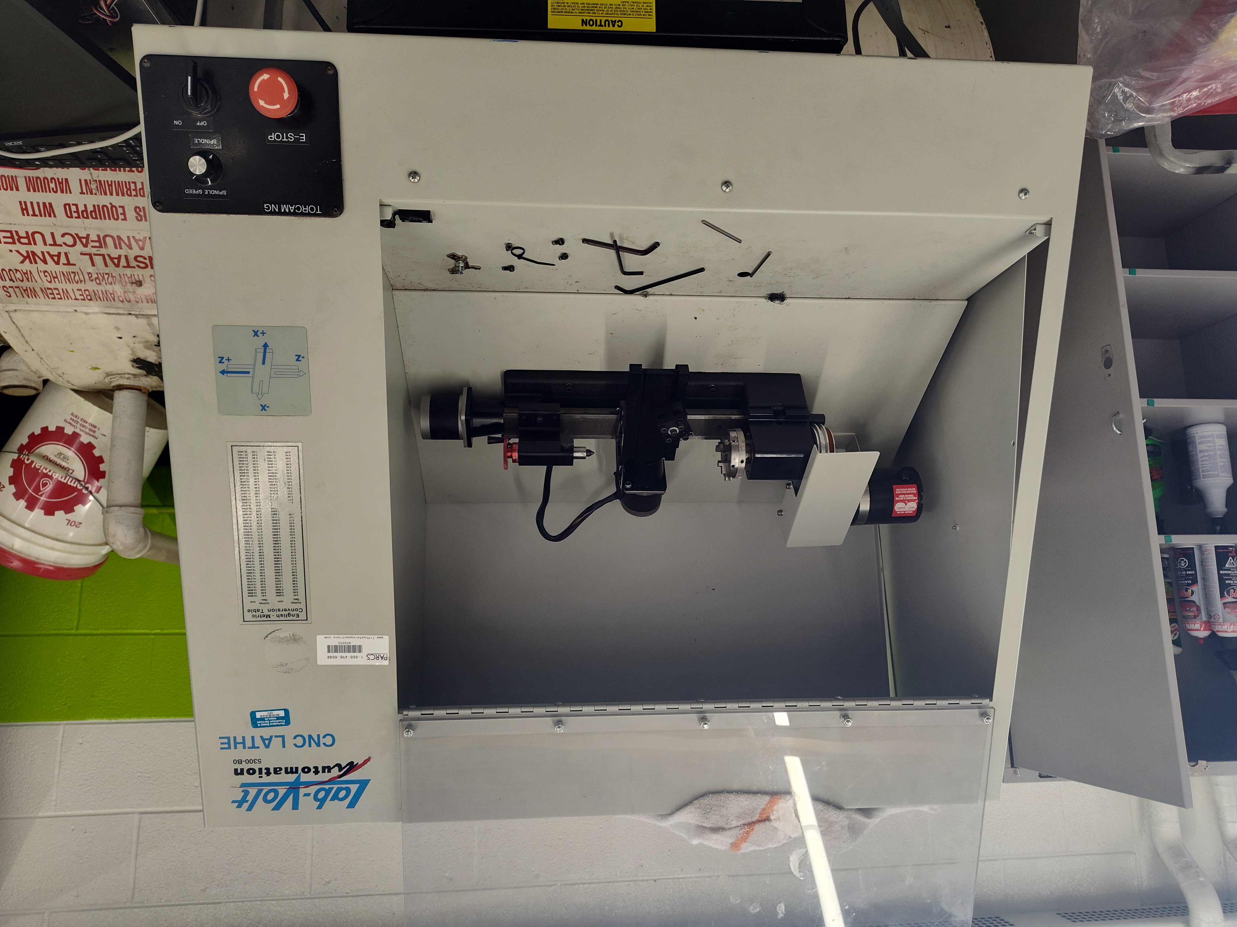 An older Lab-Volt CNC lathe being disassembled in a school technology shop.