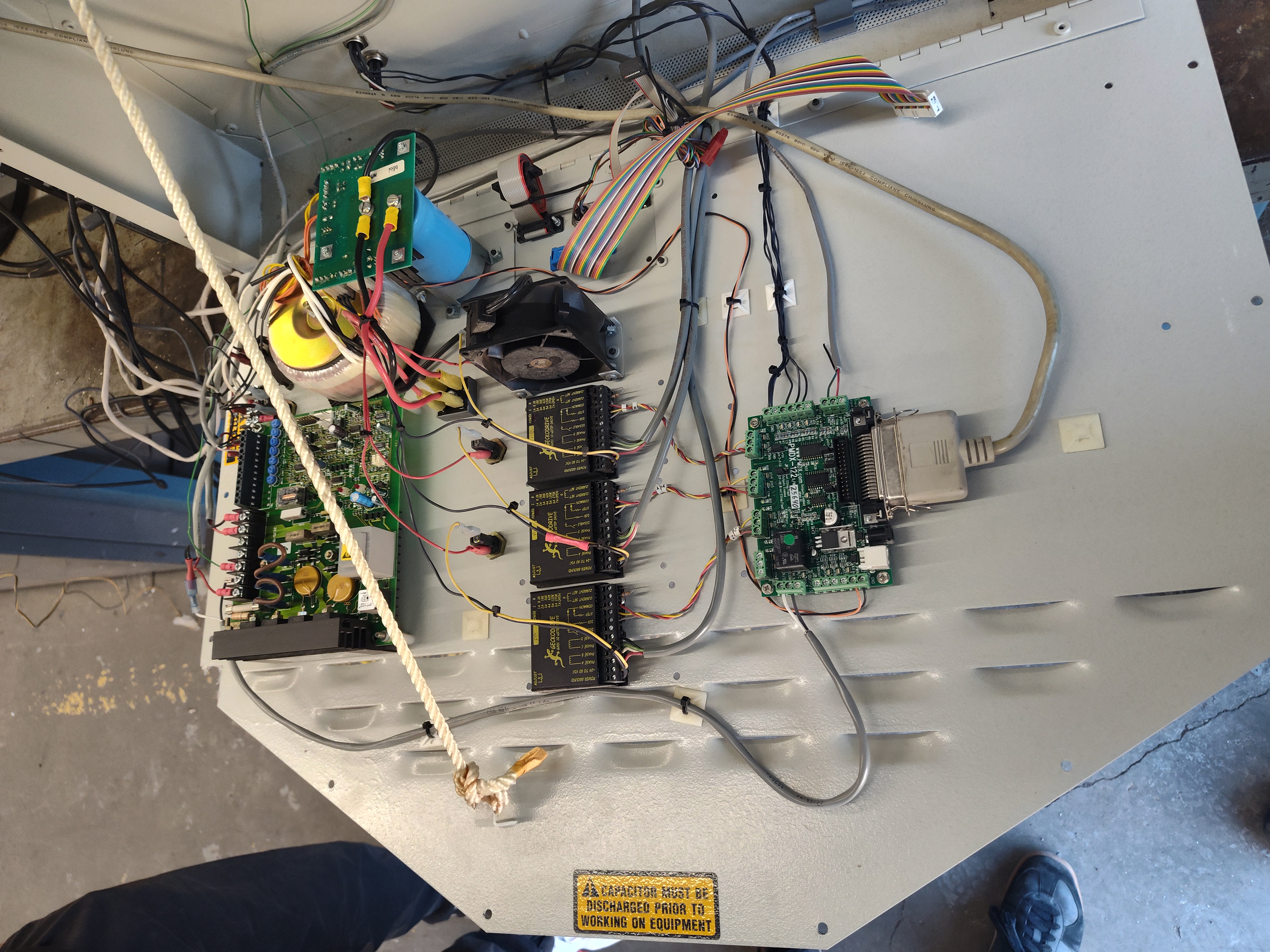 Open CNC lathe electronics cabinet showing circuit boards, drives, wiring, and power electronics.